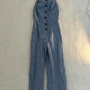 Blue and white striped jumpsuit with button-up front and wide-leg design